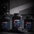 Maxi Nutrition Cyclone Strength protein powder containers with a weight plate on a dark background