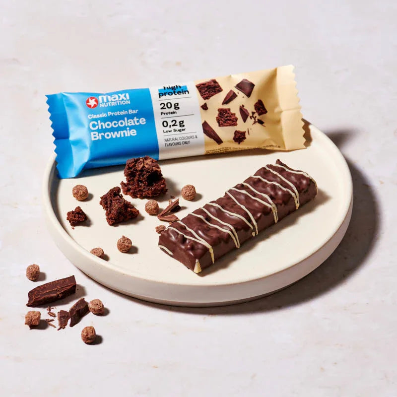 Maxi Nutrition chocolate brownie protein bar on a plate with packaging