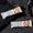 Two protein bars with a MaxiNutrition shaker bottle on a dark surface